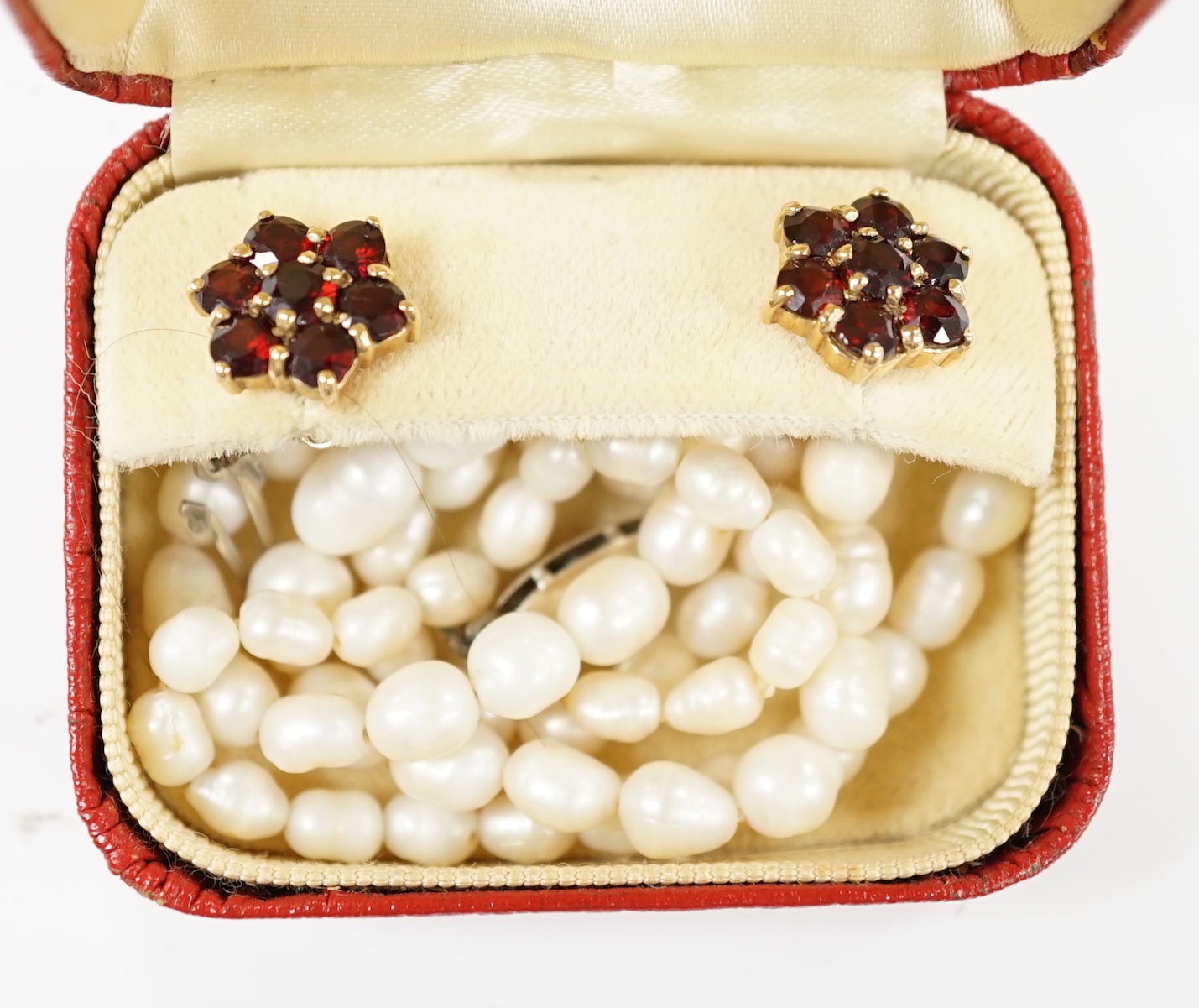 A pair of 9ct gold and garnet cluster set earrings and a freshwater? pearl necklace with a silver clasp.